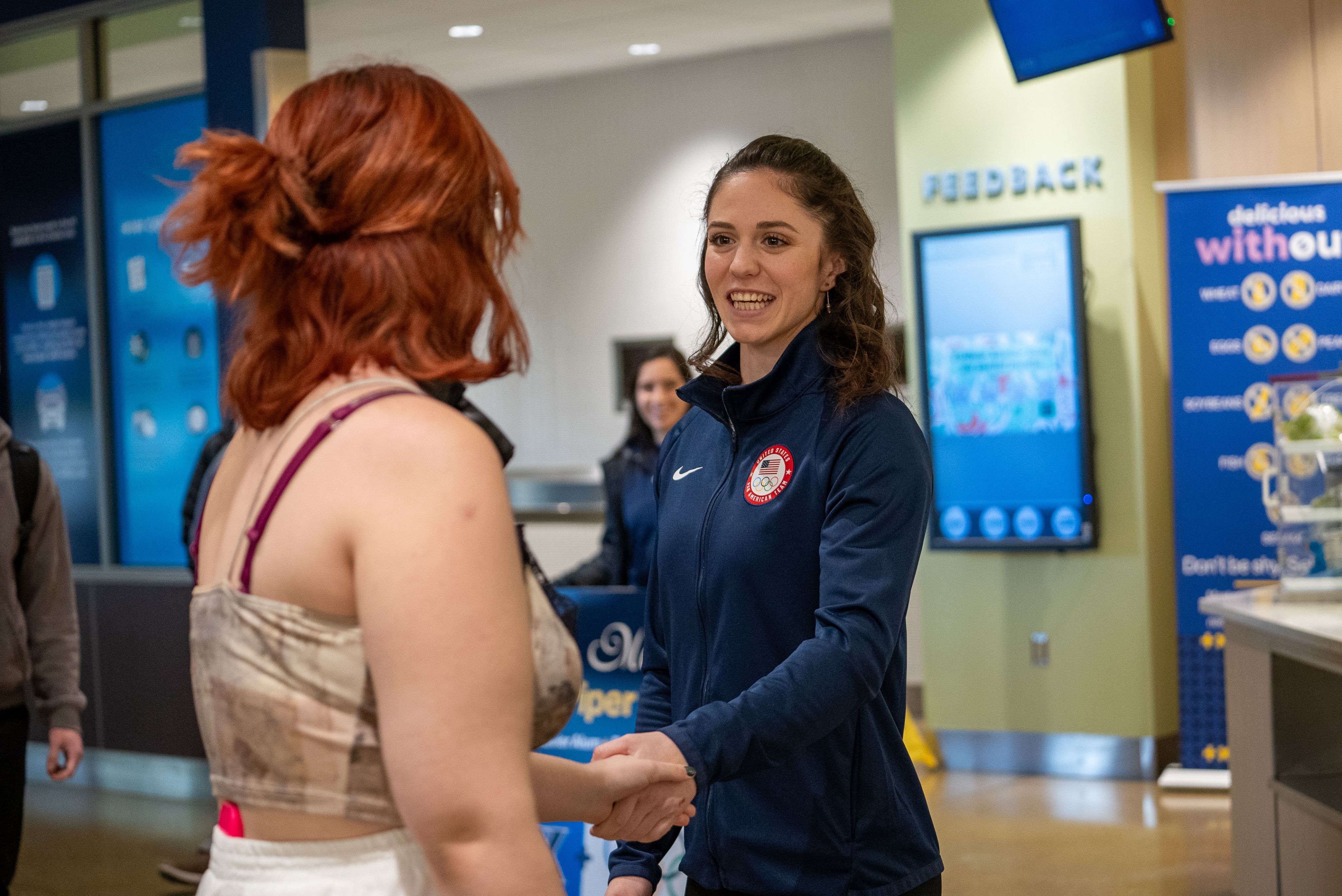 Piper Kelly talking with a Xavier student in "The Caf."