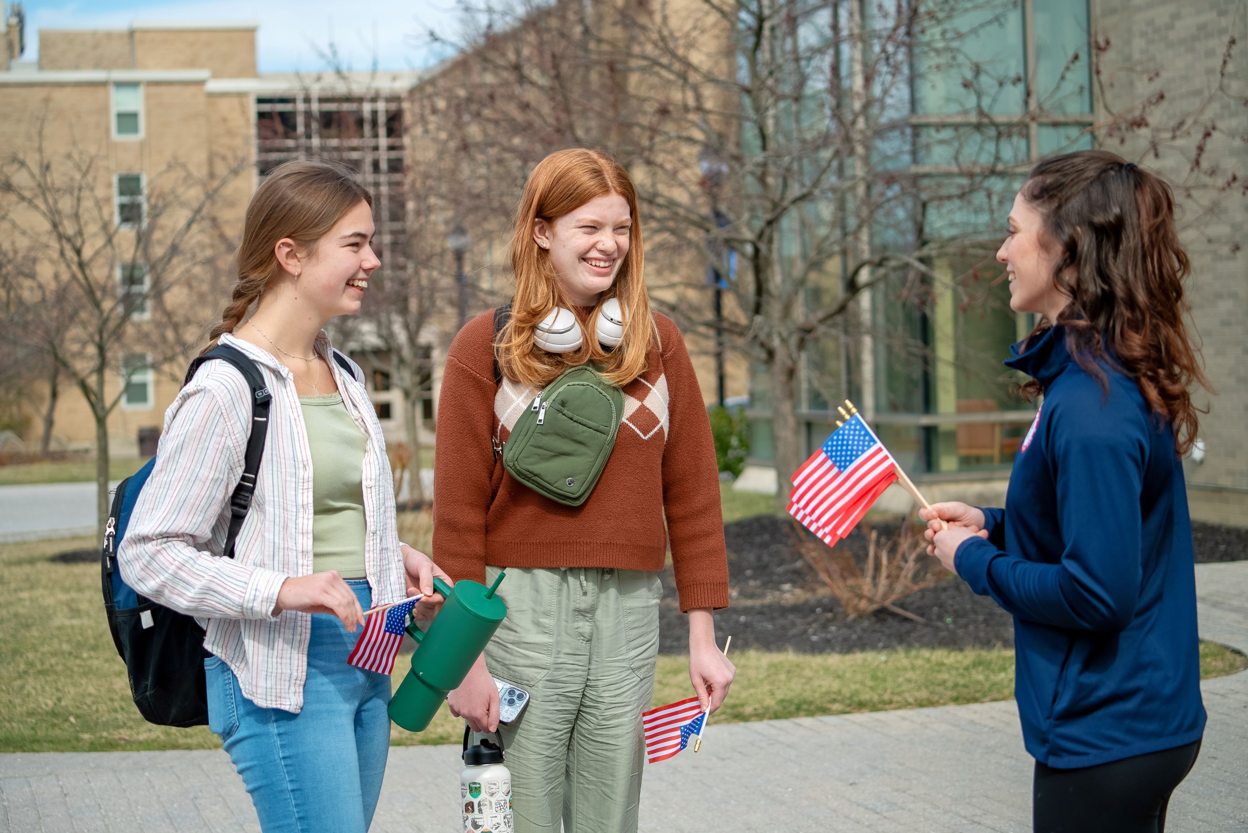 Piper Kelly talking with two Xavier students.
