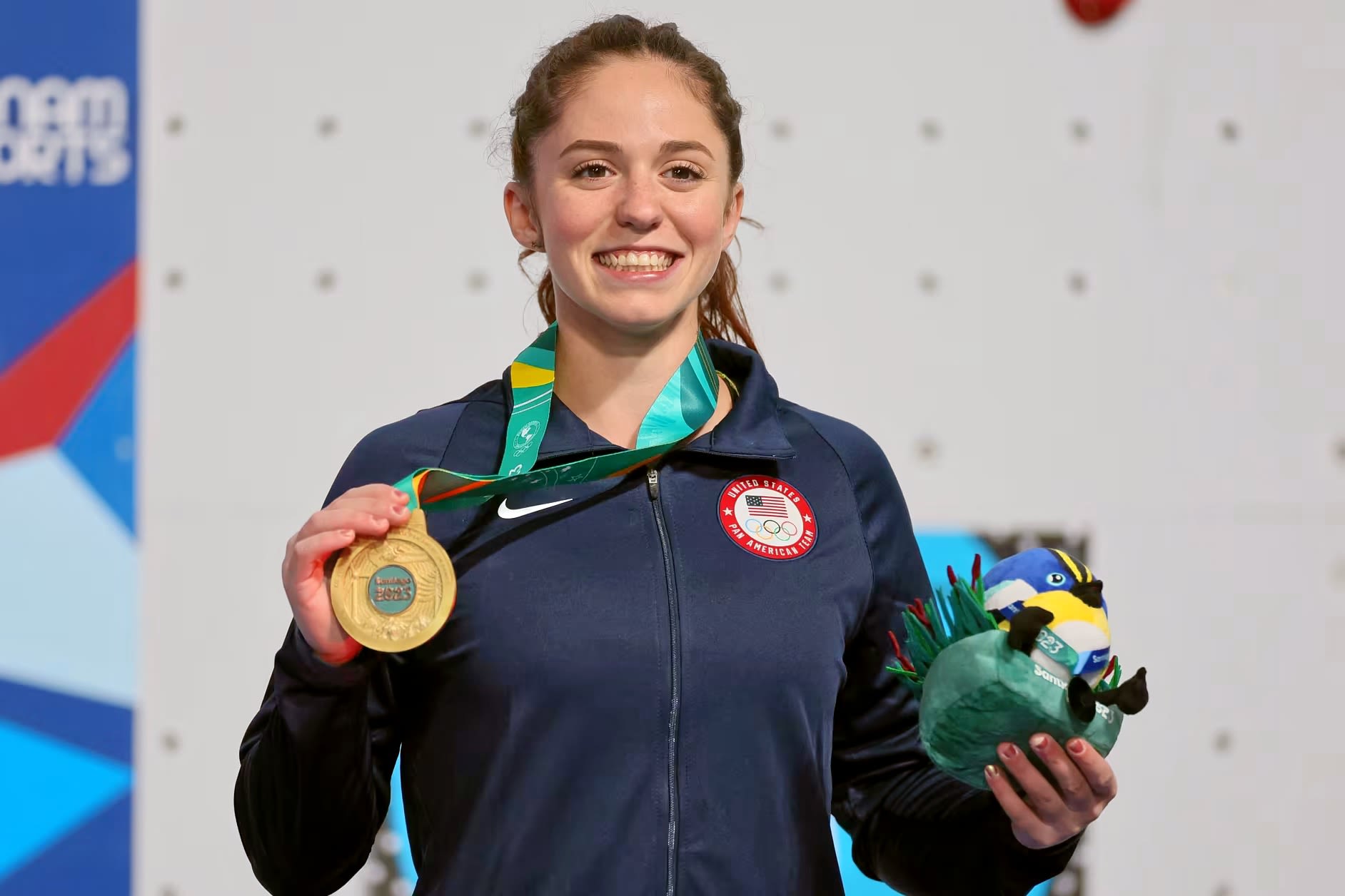 Piper Kelly holding her gold medal after she qualified for Paris Olympics.